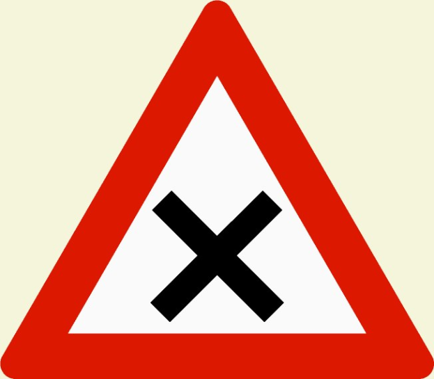 Rote und weiße dreieckige Warnstraße mit einem schwarzen Kreuz, das eine potentielle Gefahr beim Überqueren der Straße anzeigt.