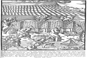 Eine Schwarz-Weiß-Zeichnung einer Gruppe von Menschen, die in einer Fabrik arbeiten, mit einem Haus im Hintergrund und einem Text unten, der lautet "A.B.C. Drei Öfen stehen am Ersten der Schmelzer".